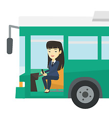 Image showing Asian bus driver sitting at steering wheel.