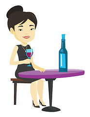 Image showing Woman drinking wine at restaurant.