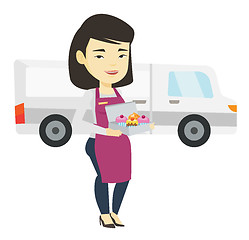 Image showing Delivery woman holding a box of cakes.