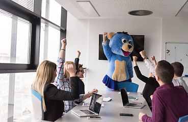 Image showing boss dresed as bear having fun with business people in trendy of