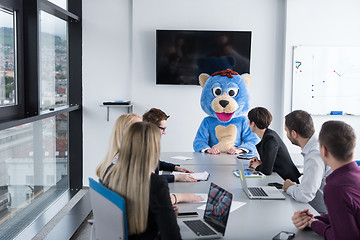 Image showing boss dresed as bear having fun with business people in trendy of