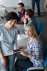 Image showing Pretty Businesswomen Using Tablet In Office Building during conf