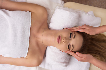 Image showing woman receiving a head massage