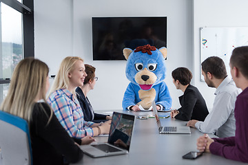 Image showing boss dresed as bear having fun with business people in trendy of