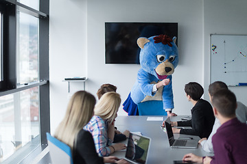 Image showing boss dresed as bear having fun with business people in trendy of