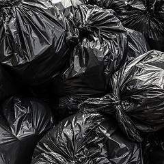 Image showing Pile of black waste plastic bin bag background.