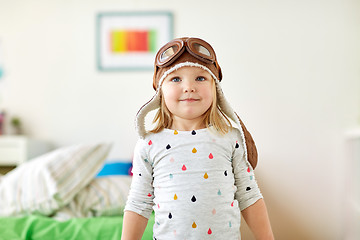 Image showing happy little girl in pilot hat playing at home