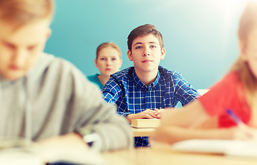 Image showing group of students with notebooks at school lesson