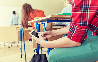 Image showing student boy with smartphone texting at school