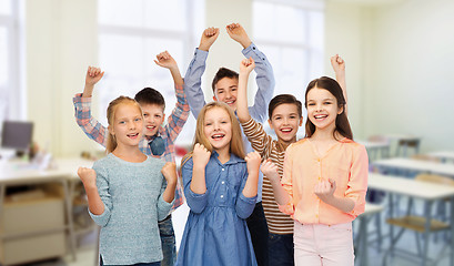 Image showing happy students celebrating victory at school