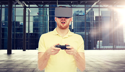 Image showing man in virtual reality headset with gamepad