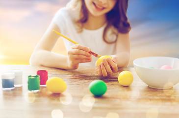 Image showing close up of girl coloring easter eggs