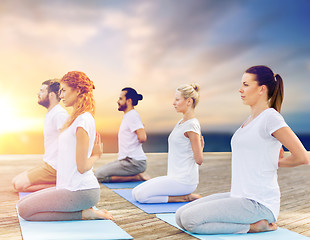 Image showing group of people doing yoga outdoors