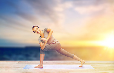 Image showing woman making yoga low angle lunge pose on mat