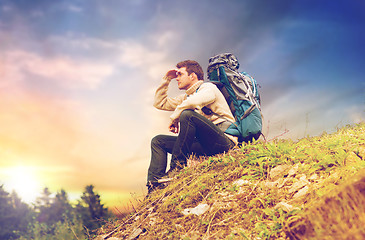 Image showing traveler with backpack hiking over sky background