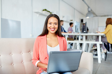 Image showing happy woman with laptop working at office