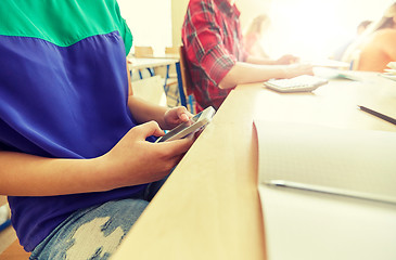 Image showing student girl with smartphone texting at school