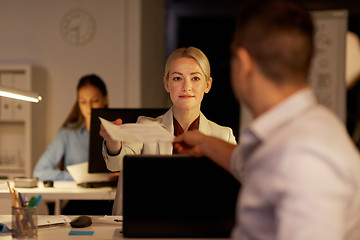 Image showing coworkers with papers working late at night office