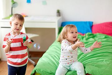 Image showing kids blowing soap bubbles and playing at home