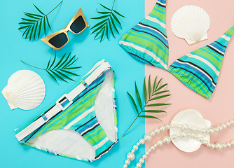 Image showing Tropical summer flat lay on turquoise and pink background