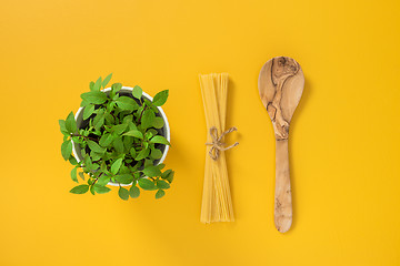 Image showing Basil, pasta and wooden spoon