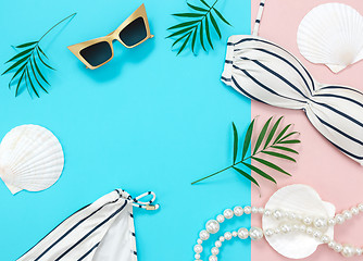 Image showing Tropical vacation flat lay on blue and pink background