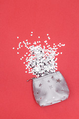 Image showing Shiny hearts spilling out of a silver purse