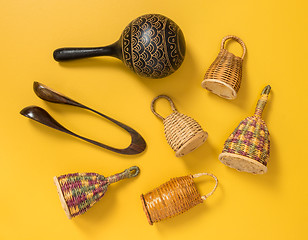 Image showing Traditional percussion instruments on yellow background