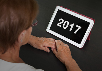 Image showing Senior lady relaxing and her tablet - 2017