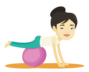 Image showing Young woman exercising with fitball.