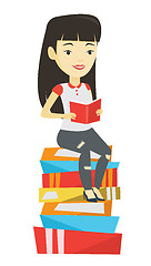 Image showing Student sitting on huge pile of books.