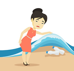 Image showing Woman showing plastic bottles under sea wave.