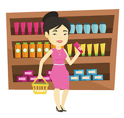 Image showing Customer with shopping basket and tube of cream.