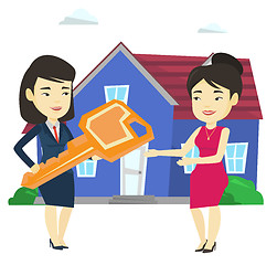 Image showing Real estate agent giving key to new house owner.