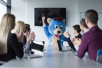 Image showing boss dresed as bear having fun with business people in trendy of