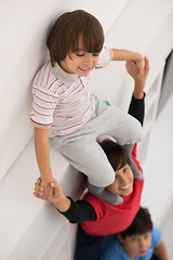 Image showing young boys posing line up piggyback top view