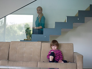 Image showing little girl playing games on smartphone