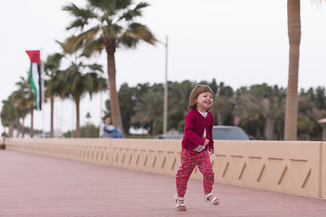 Image showing cute little girl on the promenade by the sea