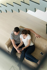 Image showing couple relaxing at  home with tablet computers