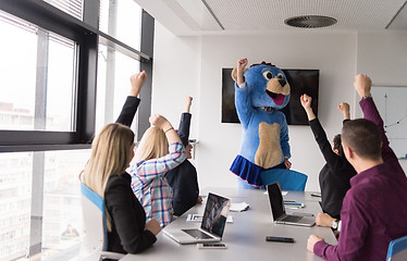 Image showing boss dresed as bear having fun with business people in trendy of