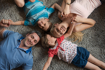 Image showing happy family lying on the floor