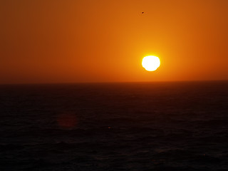 Image showing dark sunset over the ocean orange and black