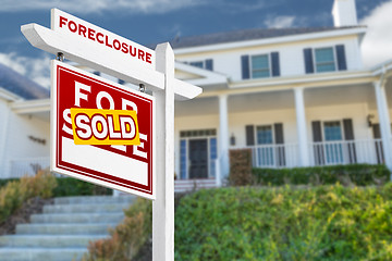 Image showing Left Facing Foreclosure Sold For Sale Real Estate Sign in Front 