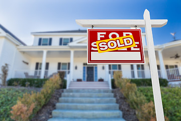 Image showing Left Facing Sold For Sale Real Estate Sign In Front of House.