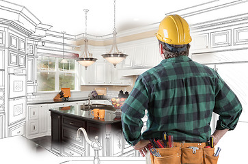 Image showing Male Contractor with Hard Hat and Tool Belt Looking At Custom Ki