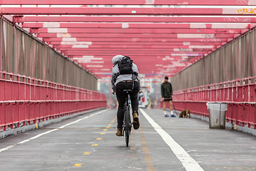 Image showing Man riding his bike in the cycling lane on Williamsburg Bridge, Brooklyn, New York City.