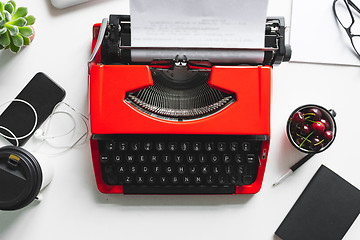 Image showing Workplace with bright red vintage typewriter