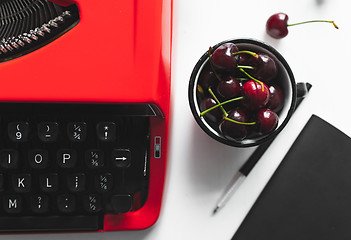 Image showing Workplace with bright red vintage typewriter