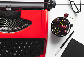 Image showing Workplace with bright red vintage typewriter