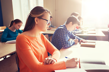 Image showing group of students with books writing school test